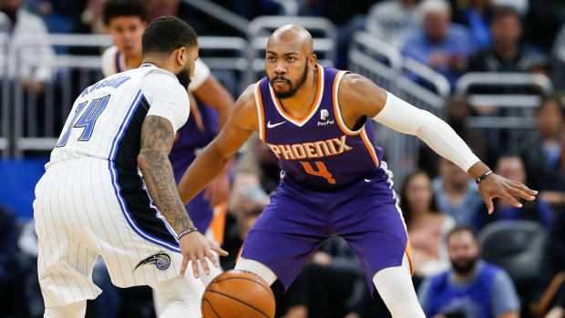 Phoenix Suns guard Jevon Carter (4) guards Orlando Magic guard D.J. Augustin (14) during the second half at Amway Center.
